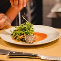 Person with Plate of Food on Table Person with Plate of Food on Table